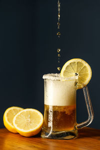 Close-up of glass of juice against black background