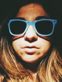 Close-up portrait of young woman wearing sunglasses