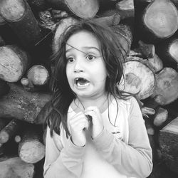 Portrait of a girl sitting on logs
