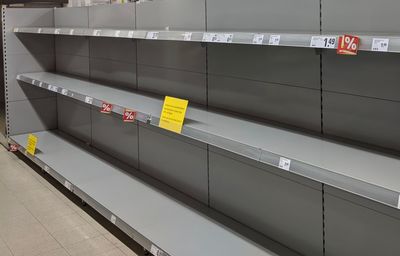 Empty toilet paper shelves in supermarket after panic buying due to outbreaking coronavirus