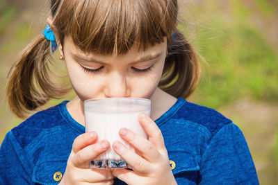 Close-up of young woman drinking juice