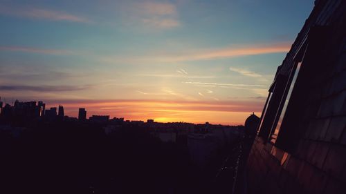 Silhouette buildings against sky during sunset