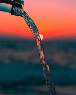 Close-up of sea against sky during sunset