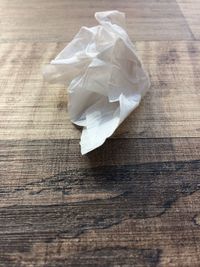 Close-up of crumpled tissue paper on wooden table