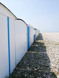 Beach huts against clear blue sky