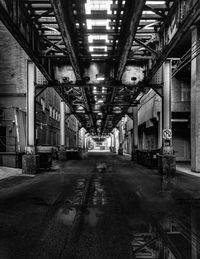 Empty road under railway bridge