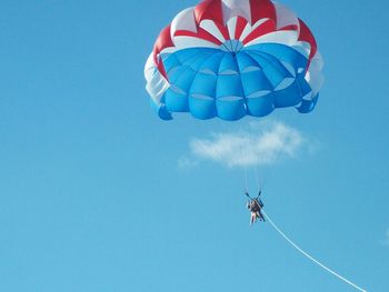 Low angle view of balloons against blue sky