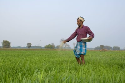 Full length of man standing on field against sky