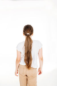 Rear view of woman standing against white background