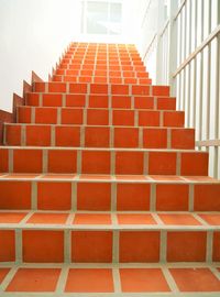 Staircase against brick wall of building