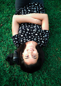 Portrait of smiling girl lying on grass