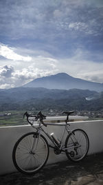 Bicycles on mountain against sky