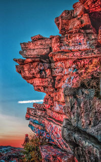 Low angle view of cliff against sky