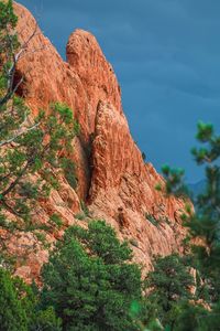 Low angle view of rock formation against sky