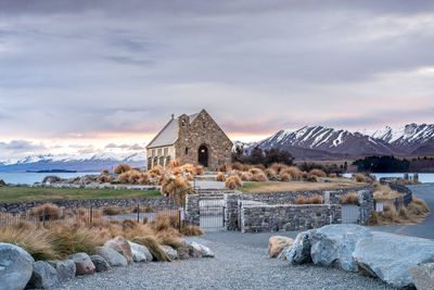 Sunrise view of the church of good shepherd with beautiful snow capped mountain range. 