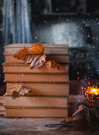 Stacked books through rainy window