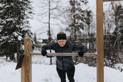 Smiling woman exercising at winter