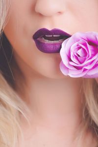 Cropped image of woman with purple rose