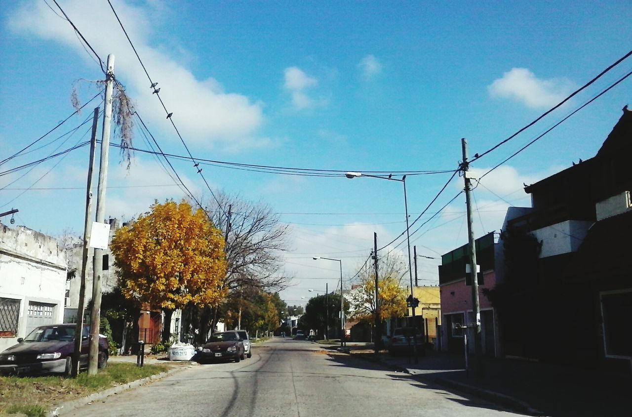 CARS ON ROAD AGAINST SKY