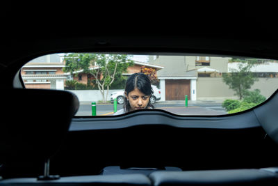 Portrait of woman sitting in car