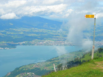 Aerial view of sign on mountain against sky