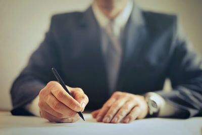 Midsection of businessman working at office