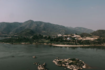 Scenic view of lake and mountains against clear sky