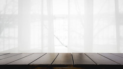 Empty table by window in foggy weather