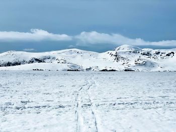 Scenic view of snowcapped mountains against sky