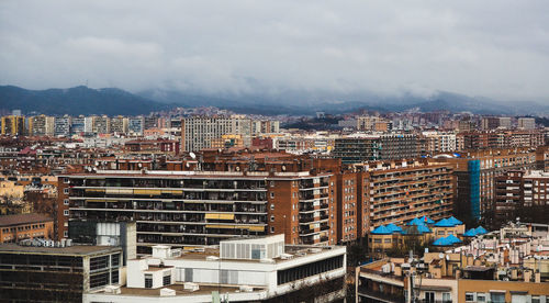 High angle view of buildings in city against sky