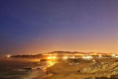 Scenic view of beach against sky at night