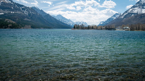 Small town on the bank of lake surrounded by mountains, shot in waterton national park, alberta