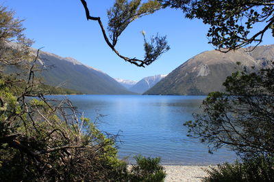 Scenic view of lake and mountains against sky