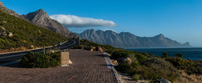 Panoramic shot of road by sea against sky