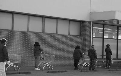 Group of people walking against building