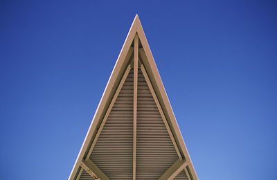 Low angle view of built structure against clear blue sky