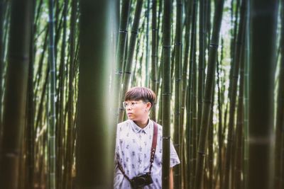 Portrait of man standing in forest