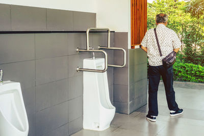 Rear view of man standing on floor