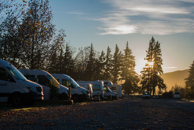 Cars on field against sky