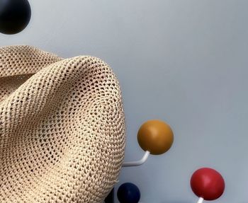 Abstract background with sun hat and colorful balls against wall
