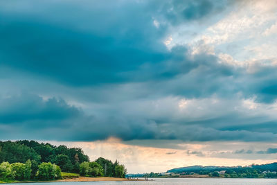 Scenic view of dramatic sky over plants