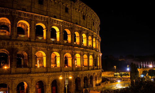 Coliseum against sky at night