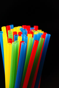 Close-up of colorful paper over black background