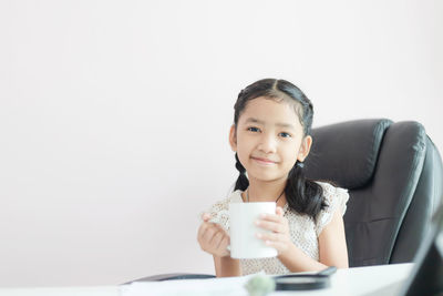 Portrait of a woman holding coffee cup