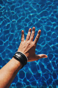 High angle view of hand on swimming pool