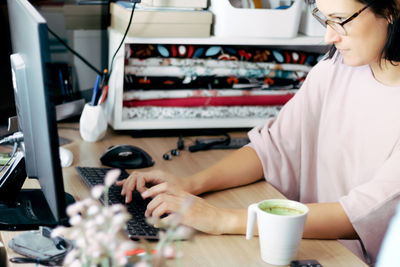 Midsection of woman working at table