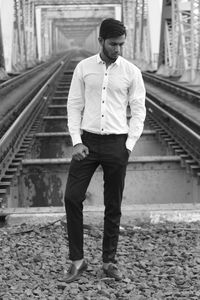 Full length of man standing on railroad track