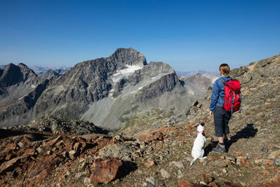 Woman on mountain against clear sky