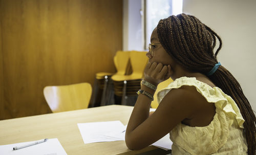 Rear view of woman studying at home