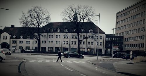 Vehicles on road along buildings